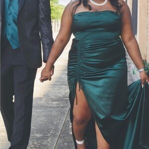 This is a silky green prom dress that is up for sale. It was only war once.